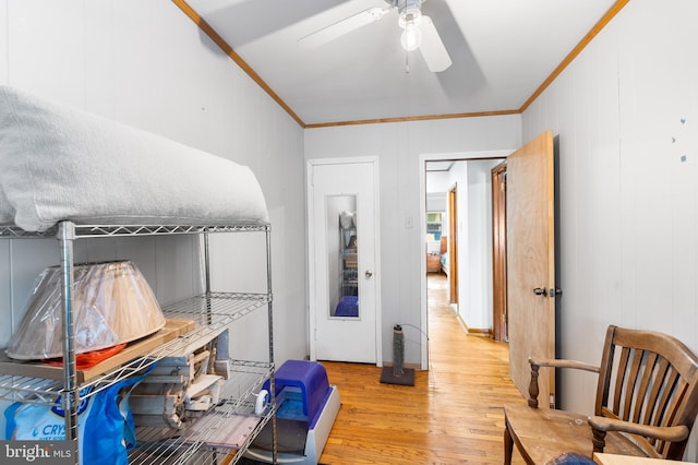 office area featuring crown molding, ceiling fan, and light hardwood / wood-style floors