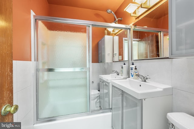 full bathroom featuring enclosed tub / shower combo, toilet, tile walls, and decorative backsplash