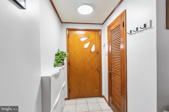 doorway featuring crown molding and light tile patterned floors