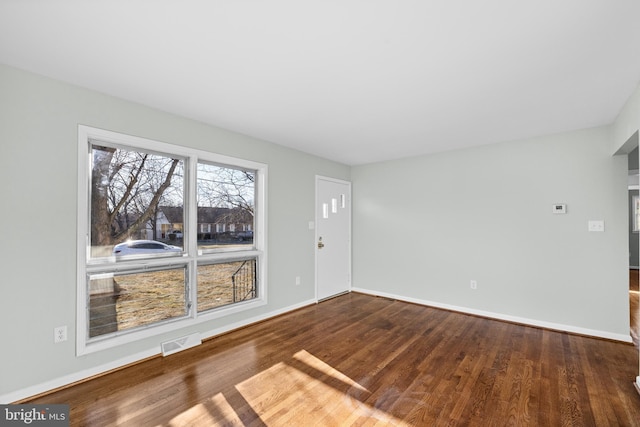 unfurnished room featuring dark hardwood / wood-style flooring