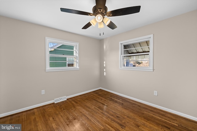 spare room with hardwood / wood-style flooring and ceiling fan