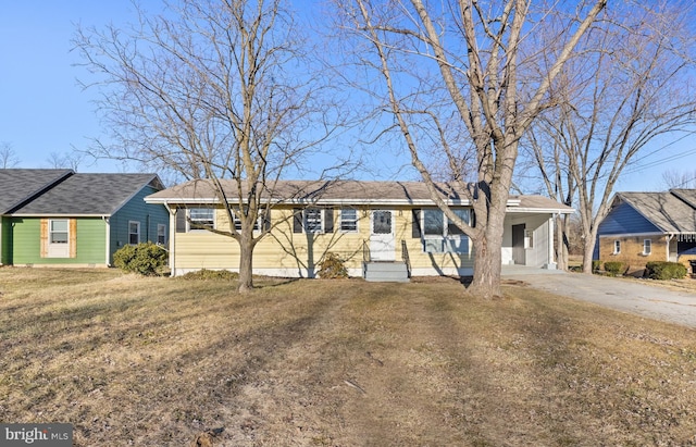 single story home featuring a front lawn and a carport