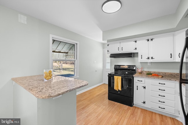 kitchen with light stone counters, light hardwood / wood-style floors, black range with electric cooktop, and white cabinets