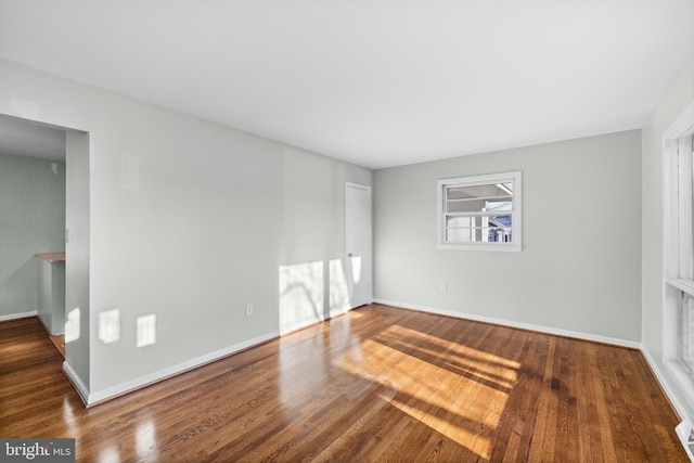 spare room featuring wood-type flooring