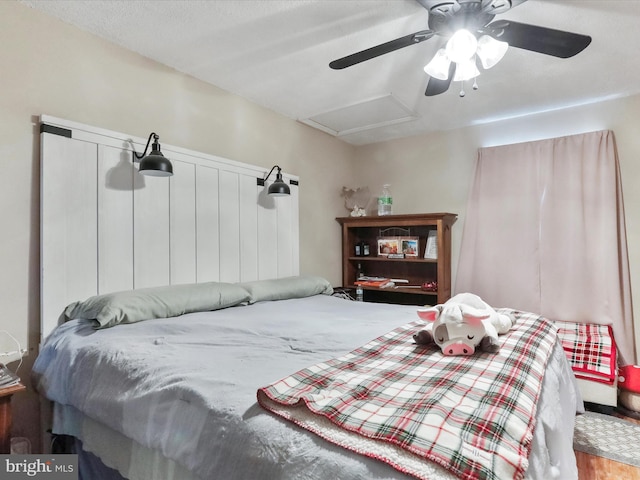 bedroom featuring hardwood / wood-style floors and ceiling fan