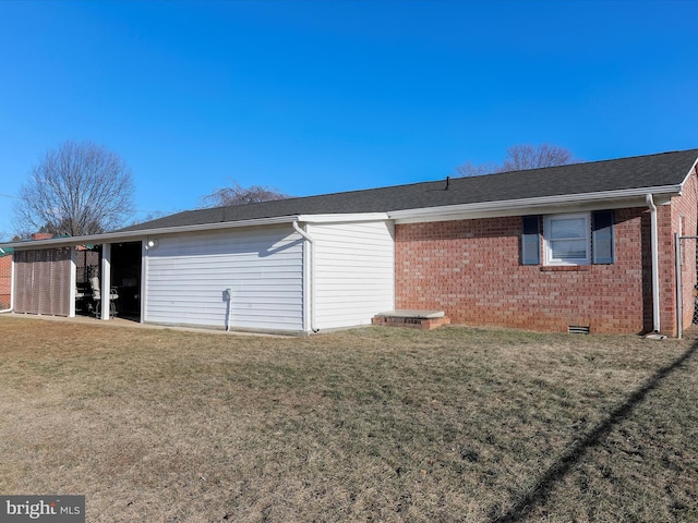 rear view of property featuring a lawn