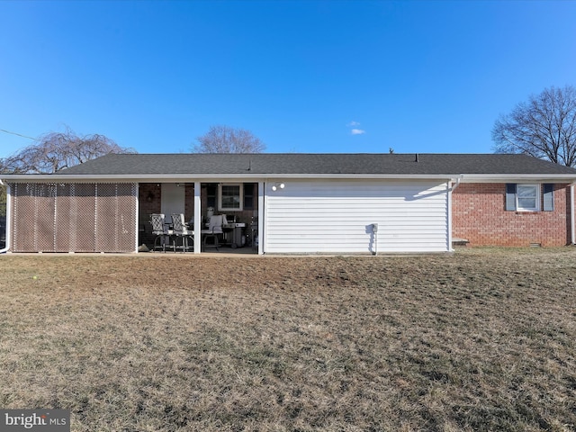 rear view of property featuring a patio and a yard