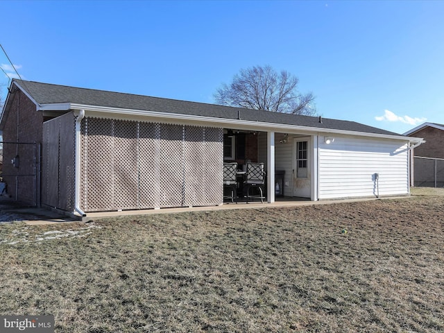 back of property featuring a lawn and a patio