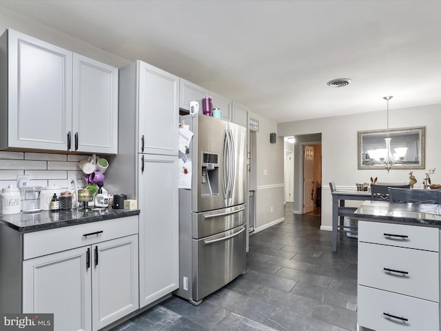 kitchen featuring white cabinetry, decorative light fixtures, stainless steel fridge with ice dispenser, and a notable chandelier