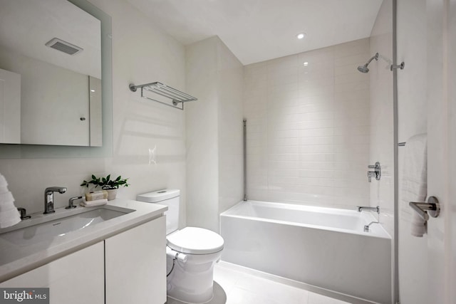 full bathroom featuring vanity, toilet, tiled shower / bath combo, and tile patterned flooring