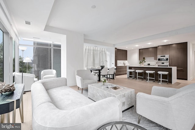 living room with light hardwood / wood-style flooring