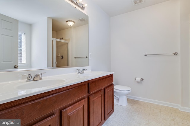 bathroom featuring toilet, a shower stall, visible vents, and a sink