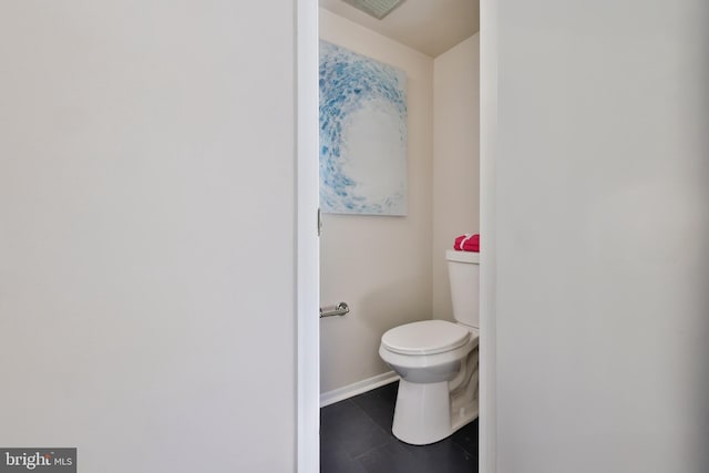 bathroom with toilet and tile patterned flooring