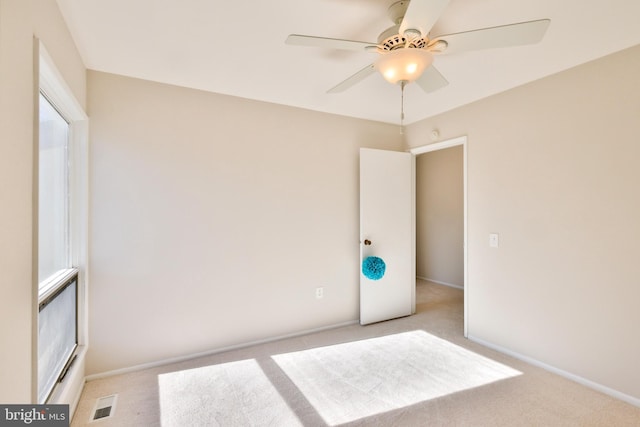 carpeted empty room with ceiling fan