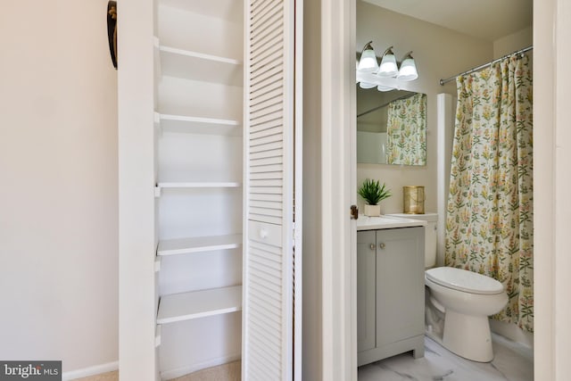 bathroom featuring vanity and toilet