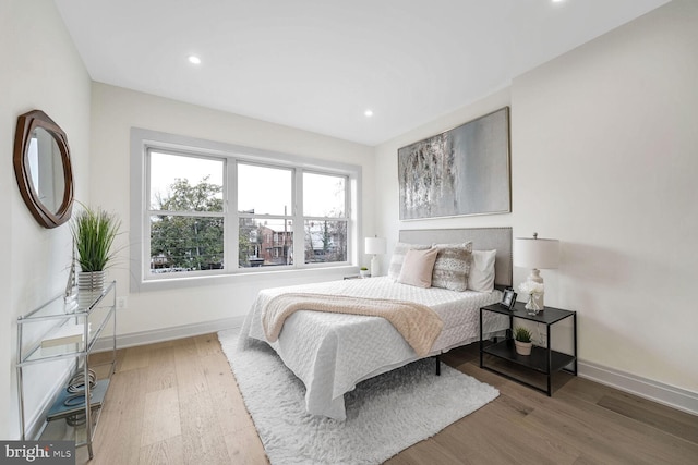 bedroom with hardwood / wood-style floors