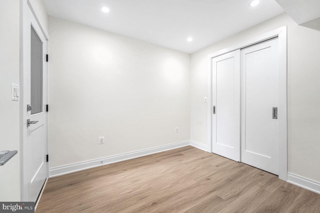 unfurnished bedroom with light hardwood / wood-style floors and a closet