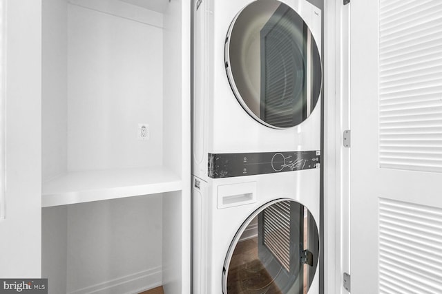 laundry area featuring stacked washing maching and dryer