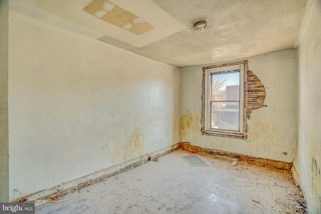 spare room featuring a textured ceiling