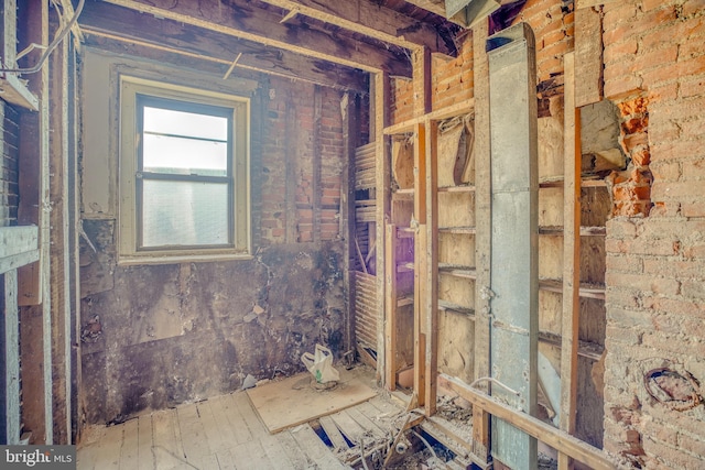 miscellaneous room with brick wall