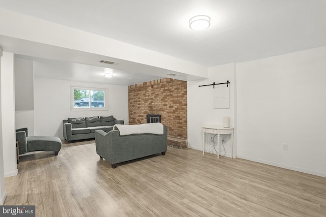 living room with light hardwood / wood-style flooring and a barn door