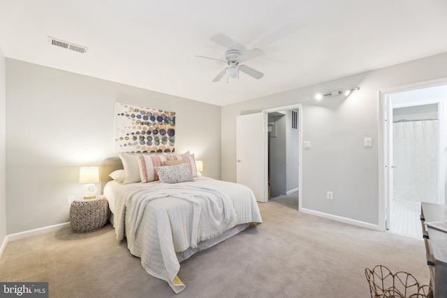 carpeted bedroom featuring ceiling fan and a walk in closet