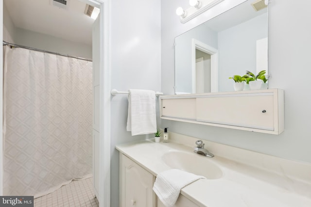 bathroom featuring tile patterned flooring and vanity