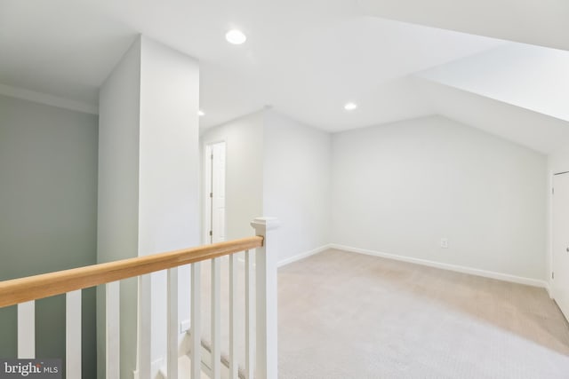 additional living space featuring lofted ceiling and light colored carpet