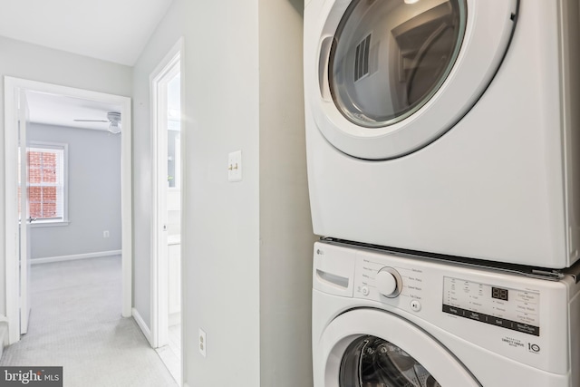 washroom with stacked washer / dryer and light carpet