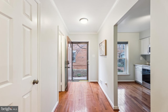 doorway to outside featuring ornamental molding and hardwood / wood-style floors