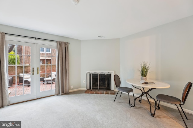 sitting room featuring french doors and carpet flooring