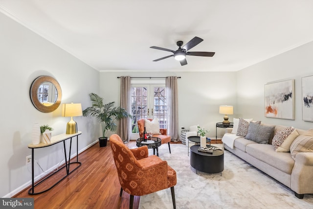 living room featuring wood-type flooring, ceiling fan, and french doors