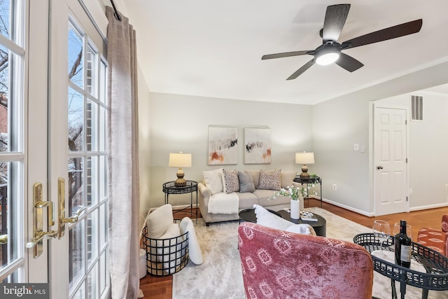 living room featuring ceiling fan and wood-type flooring