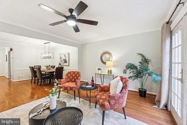 living room with light hardwood / wood-style floors and ceiling fan