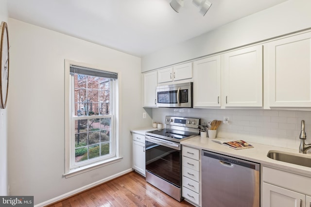 kitchen featuring white cabinetry, appliances with stainless steel finishes, sink, and plenty of natural light