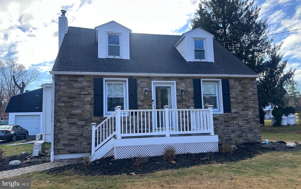 cape cod house featuring a garage