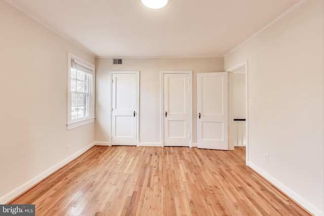 unfurnished bedroom featuring light hardwood / wood-style flooring and ornamental molding