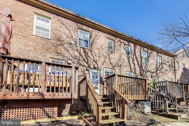 rear view of house featuring central AC and a deck