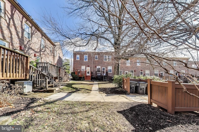 view of yard with central AC and a deck