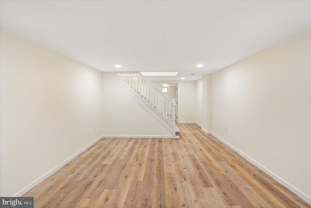 basement with light hardwood / wood-style floors