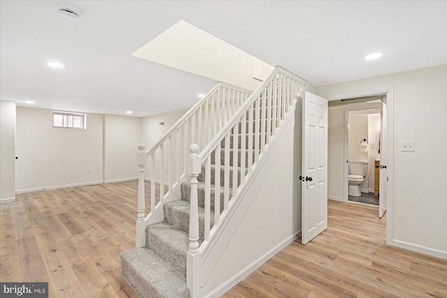 stairs featuring hardwood / wood-style floors