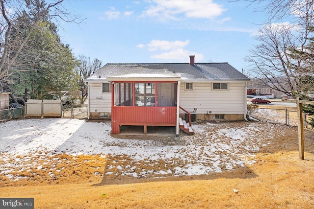 back of house featuring a sunroom