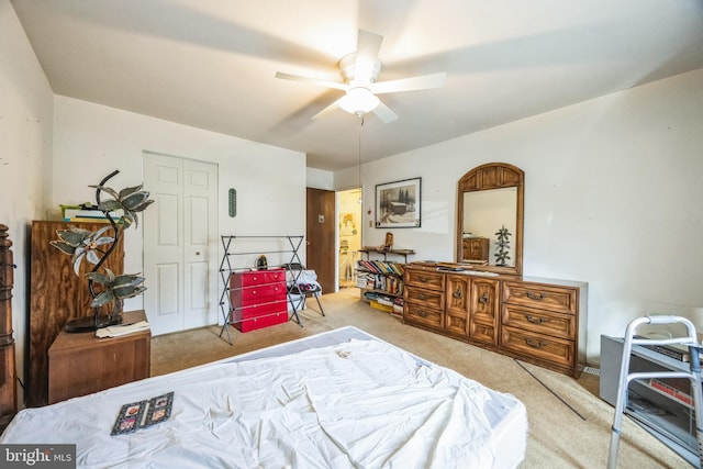 bedroom with light colored carpet, a closet, and ceiling fan