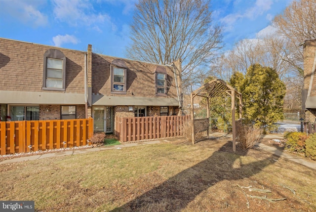 rear view of house with a yard