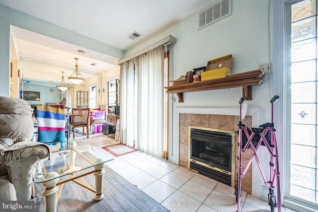 living room featuring a fireplace and light tile patterned floors