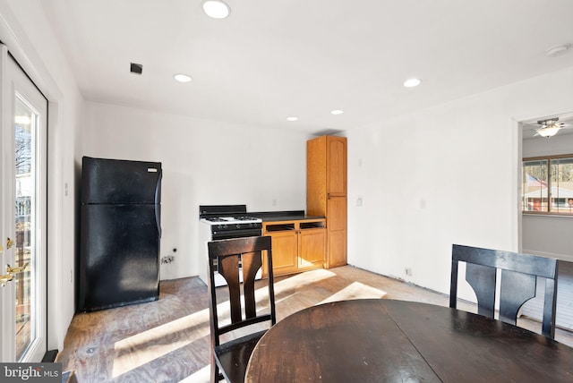 kitchen featuring black refrigerator, gas range, and light wood-type flooring