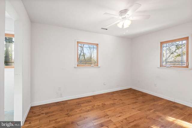 empty room with ceiling fan and wood-type flooring