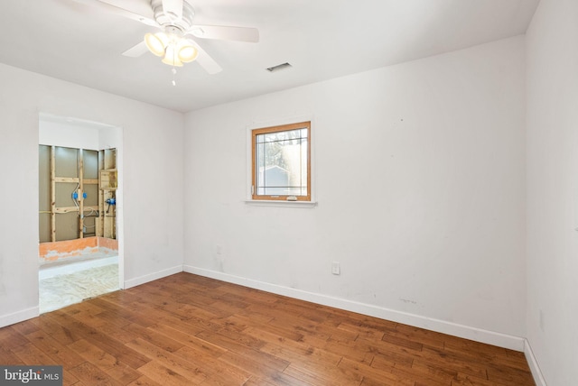 unfurnished room with ceiling fan and hardwood / wood-style floors