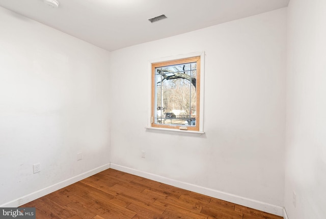 spare room featuring hardwood / wood-style floors