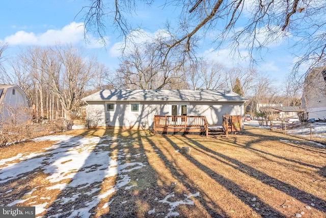 view of front of property with a deck and a lawn